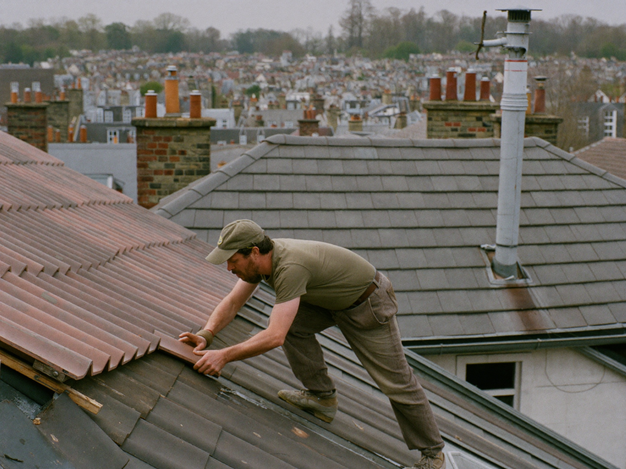 Roofer laying new tiles on a Bristol roof